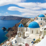 36322887 - panoramic view of the oia village under puffy clouds, santorini island, greece